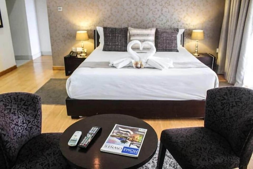 Premium bedding, desk, laptop workspace, blackout drapes