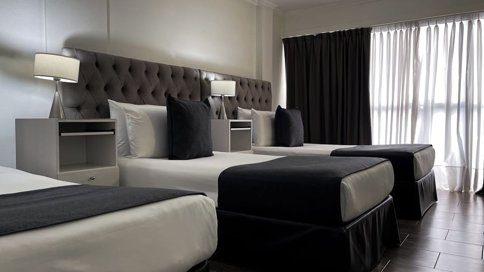 Executive Triple Room | Minibar, in-room safe, desk, soundproofing