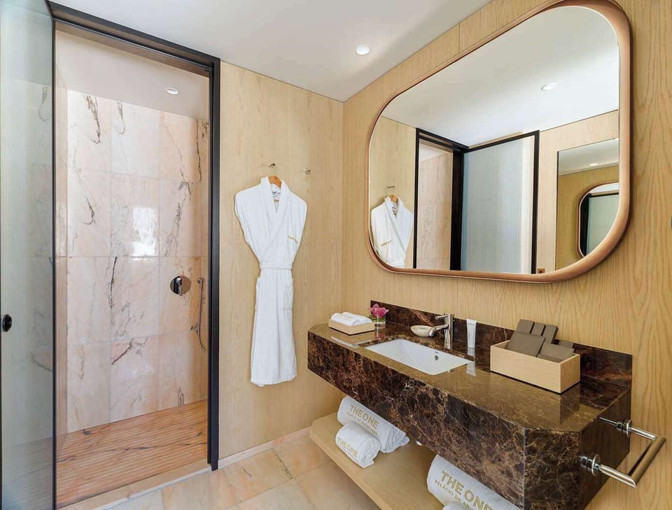 Designer toiletries, hair dryer, bathrobes, slippers
