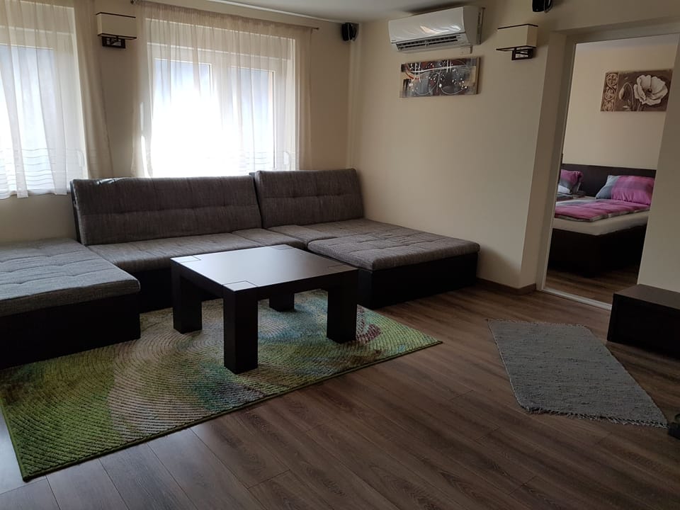 Apartment, 4 Bedrooms | Living room | Flat-screen TV