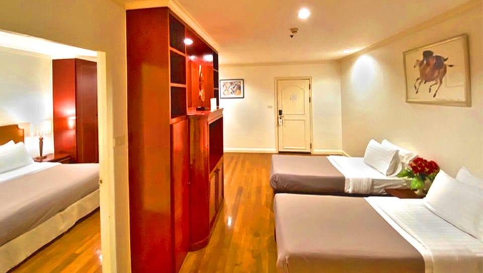 Deluxe Family room | Free minibar items, in-room safe, desk, laptop workspace