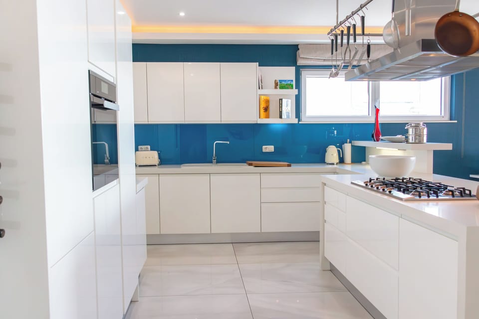 Oasis Apartment | Private kitchen | Microwave, coffee/tea maker, electric kettle, highchair