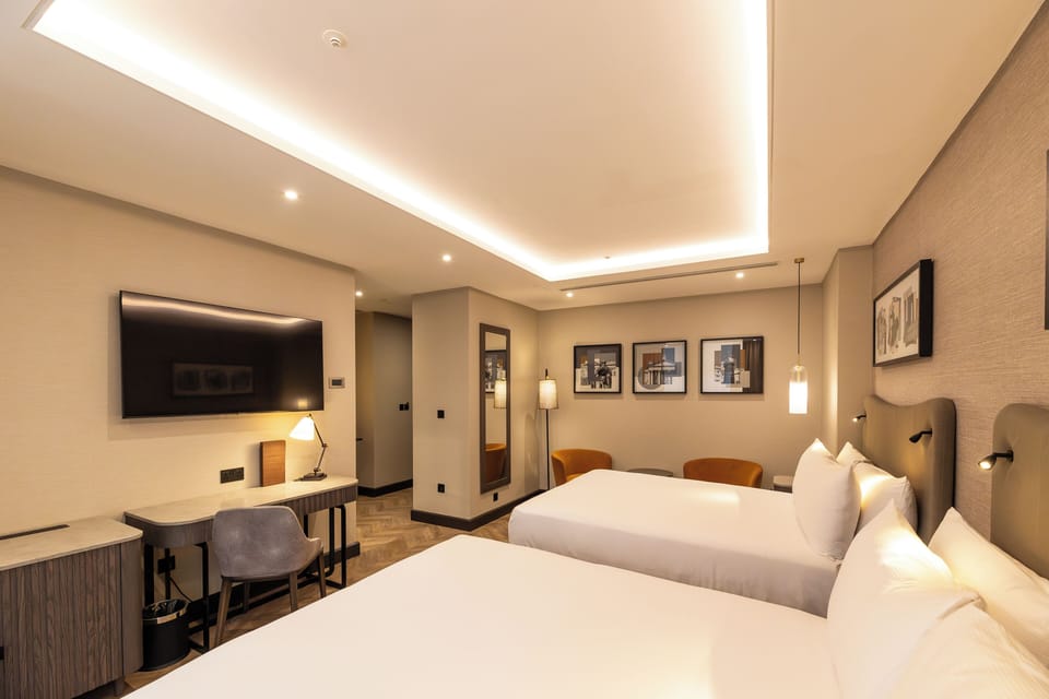 Deluxe Room, 2 Double Beds | In-room safe, desk, laptop workspace, blackout drapes