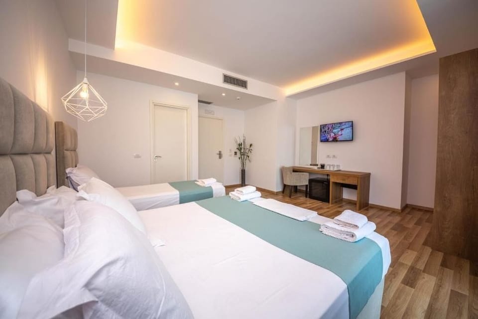 Deluxe Triple Room, Balcony | Minibar, in-room safe, desk, blackout drapes