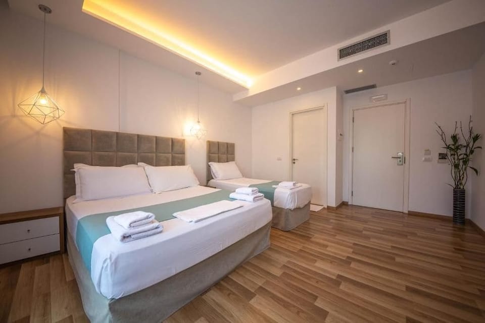 Deluxe Triple Room, Balcony | Minibar, in-room safe, desk, blackout drapes