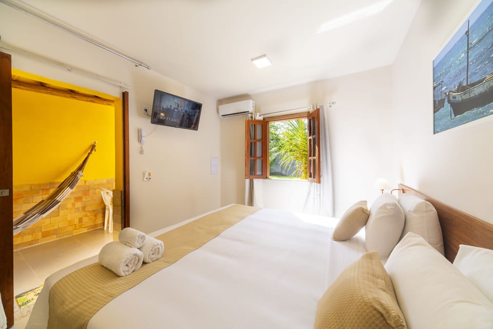 Deluxe Room, 1 King Bed, Patio, Ground Floor | Minibar, in-room safe, desk, laptop workspace