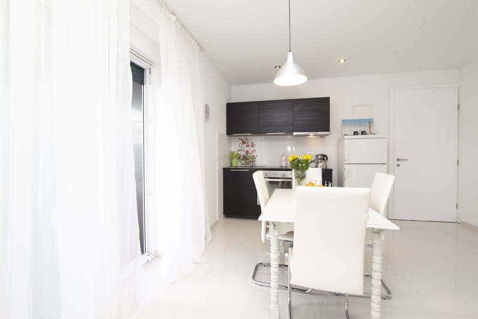 Two-Bedroom Apartment with Sea View and Balcony | Private kitchen | Coffee/tea maker, highchair, cleaning supplies, dining tables