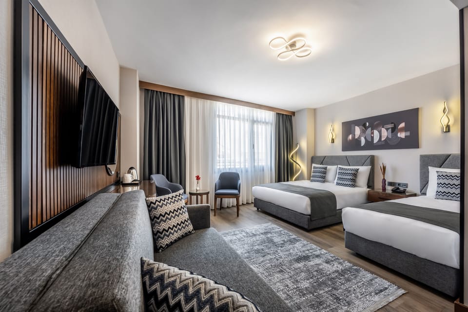 Deluxe Quadruple Room | 1 bedroom, minibar, in-room safe, desk