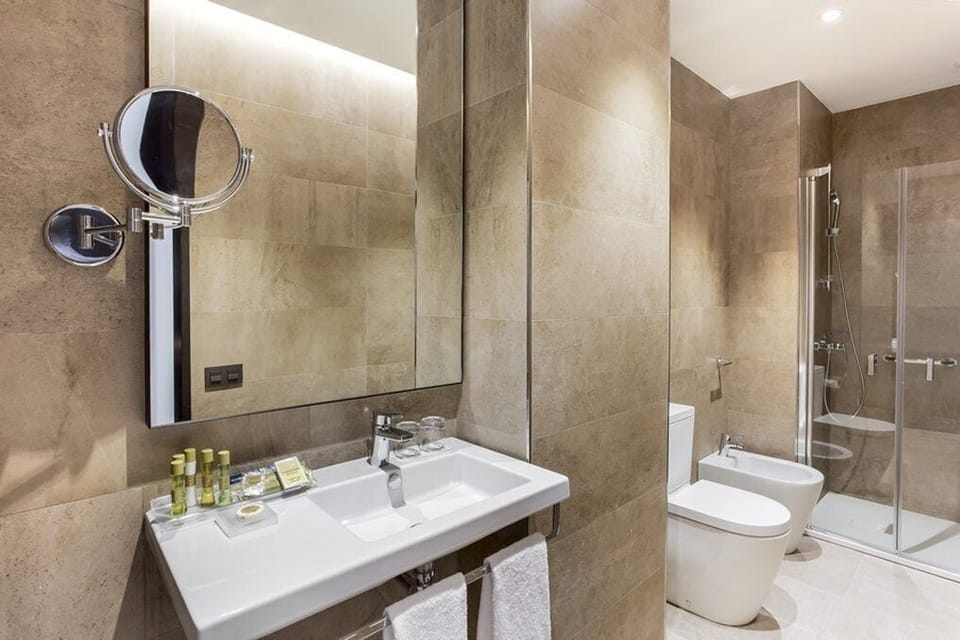 Deep soaking tub, rainfall showerhead, eco-friendly toiletries