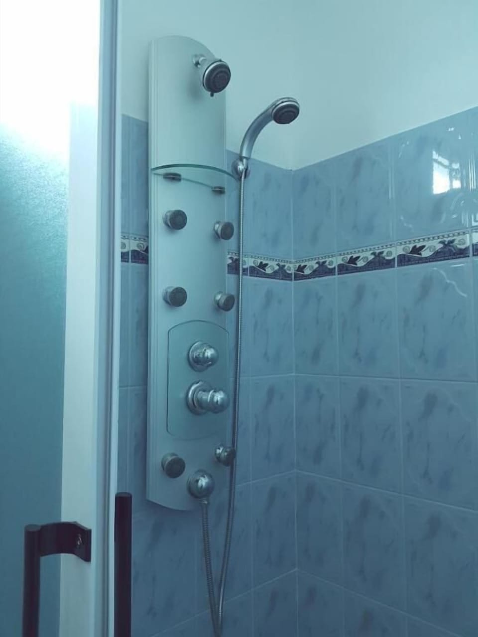 Shower, rainfall showerhead, hair dryer, towels