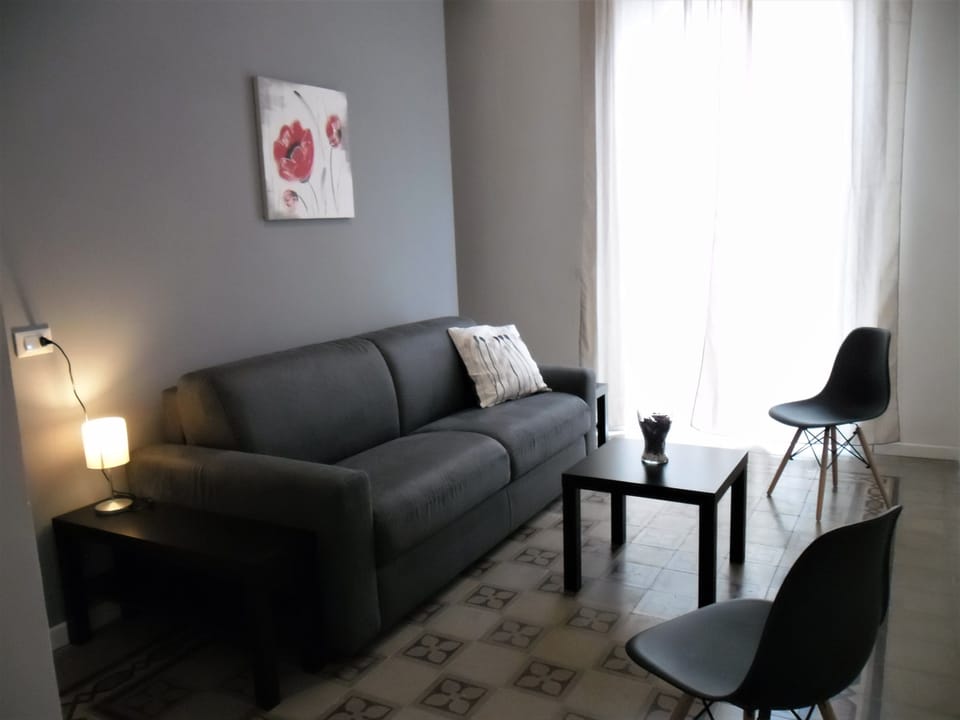 Quadruple Room | Living area | Flat-screen TV