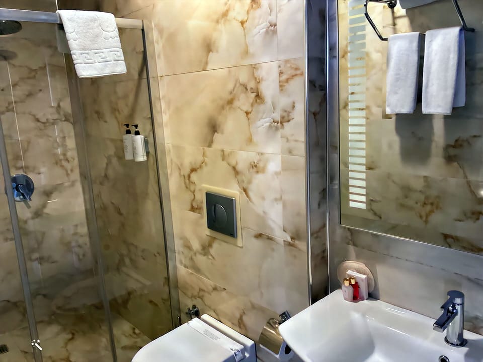 Shower, rainfall showerhead, designer toiletries, hair dryer