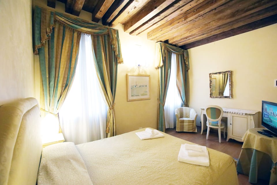 Triple Room, Canal View | In-room safe, desk, blackout drapes, iron/ironing board