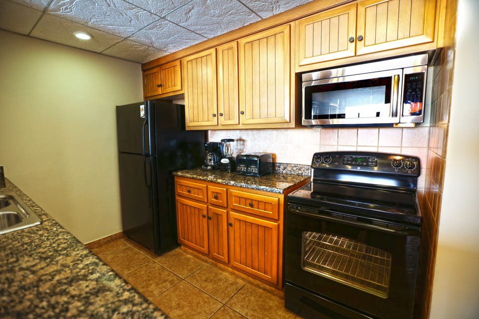 Microwave, coffee/tea maker, cleaning supplies