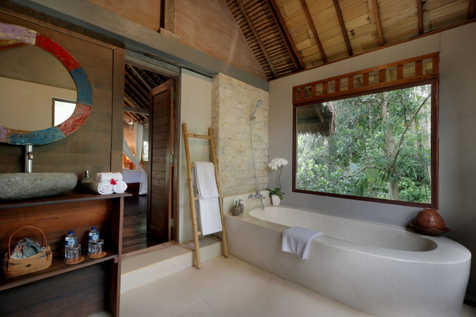 Suite, River View | Bathroom | Shower, rainfall showerhead, free toiletries, slippers