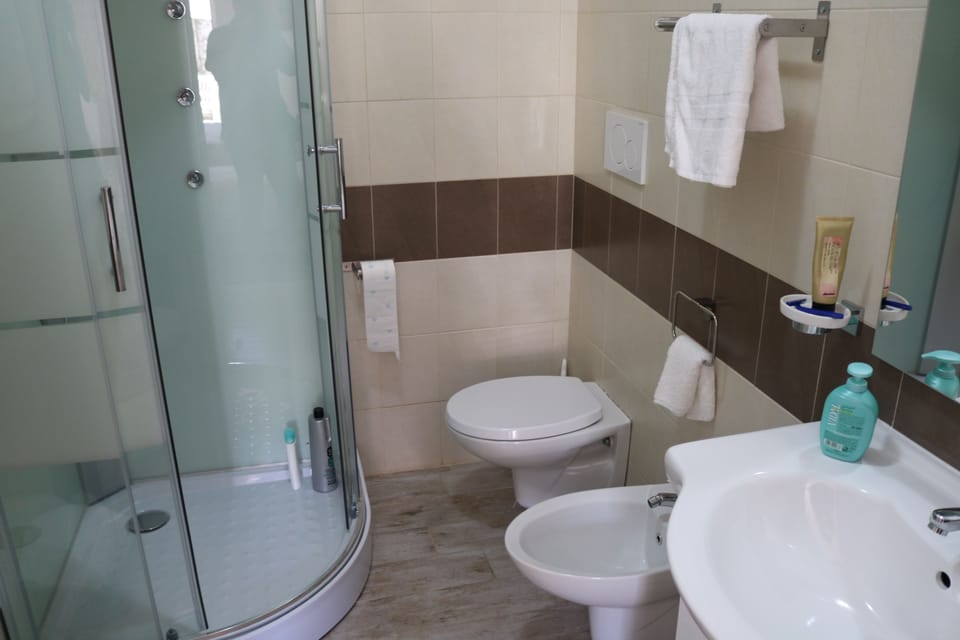Triple Room, Balcony, Garden View | Bathroom | Shower, rainfall showerhead, free toiletries, hair dryer