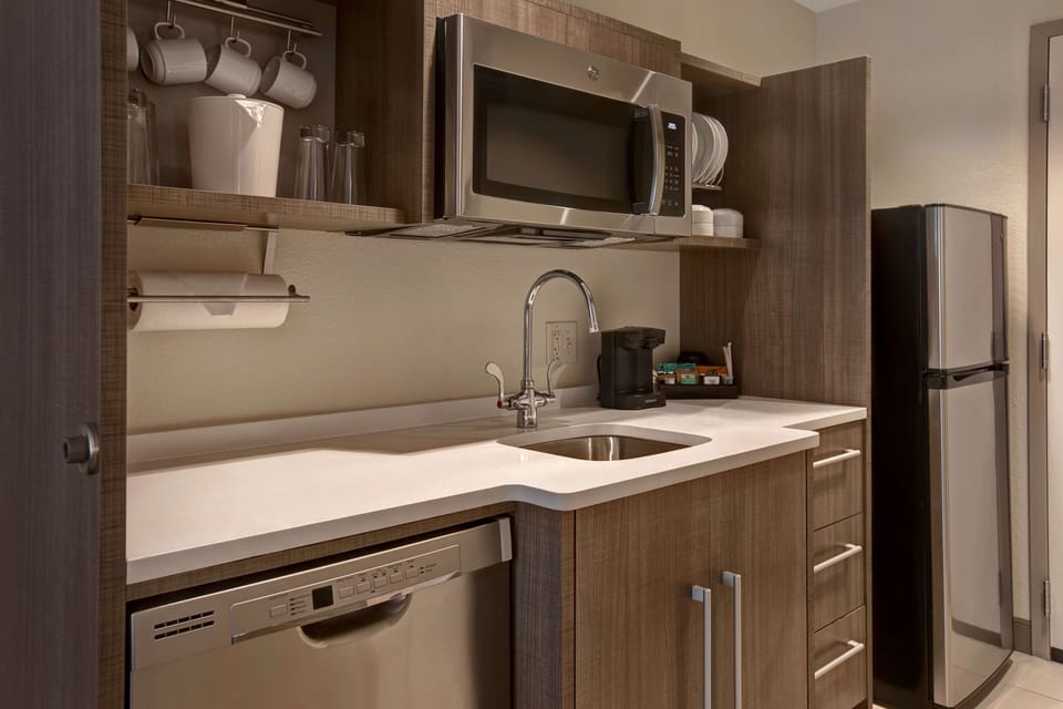 Fridge, microwave, coffee/tea maker, cookware/dishes/utensils
