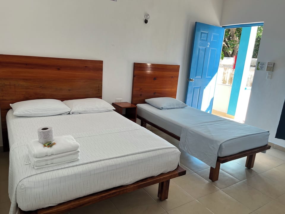 Basic Triple Room, Multiple Beds, Non Smoking, Ocean View | Pillowtop beds, bed sheets