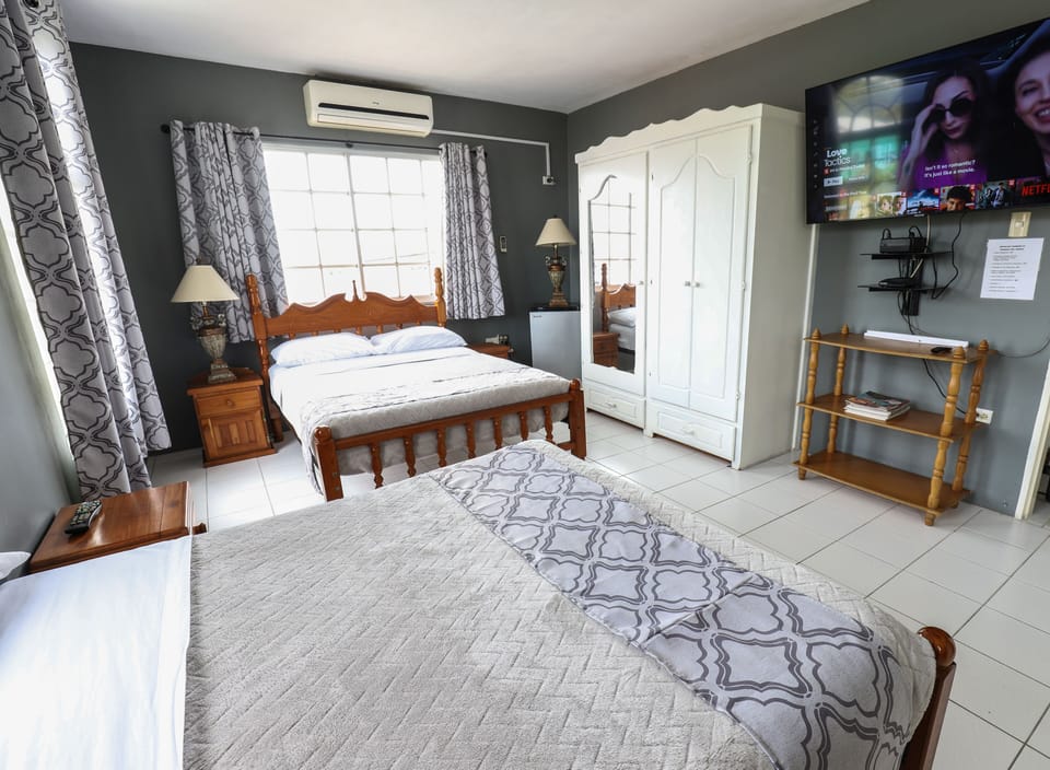 Comfort Quadruple Room, 2 Double Beds, Refrigerator, Garden View | Desk, iron/ironing board, WiFi (free), bed sheets