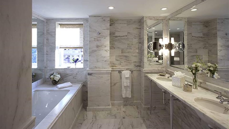 Bathtub, designer toiletries, hair dryer, bathrobes