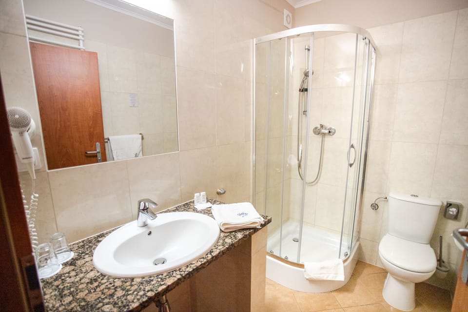 Shower, designer toiletries, hair dryer, towels