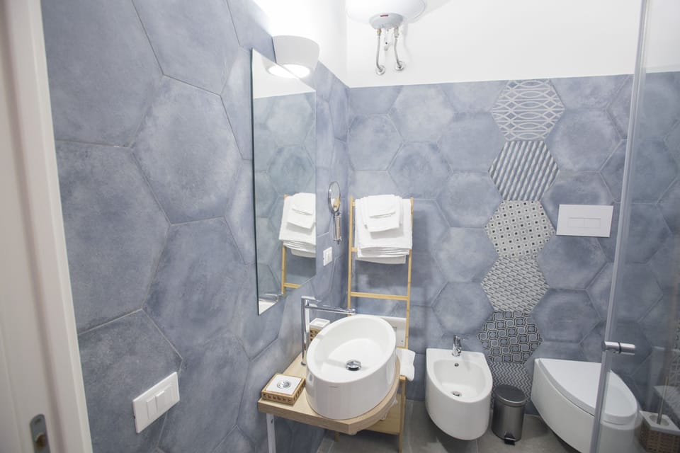Deluxe Double Room, City View | Bathroom | Shower, free toiletries, hair dryer, slippers