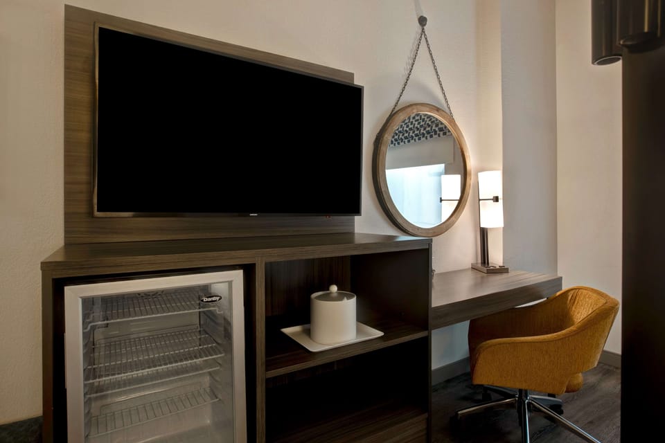 Hypo-allergenic bedding, desk, laptop workspace, blackout drapes