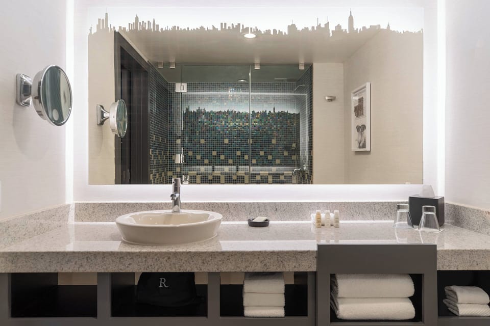 Shower, designer toiletries, hair dryer, towels