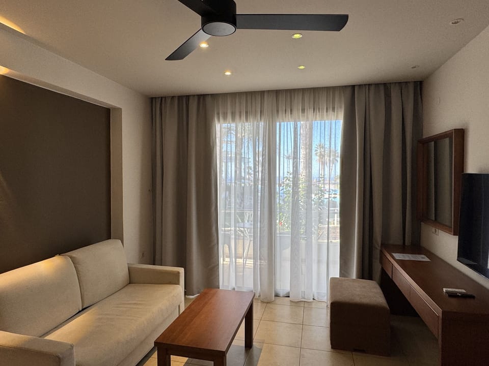 Suite with Pool View | Living area | 55-inch Smart TV with satellite channels