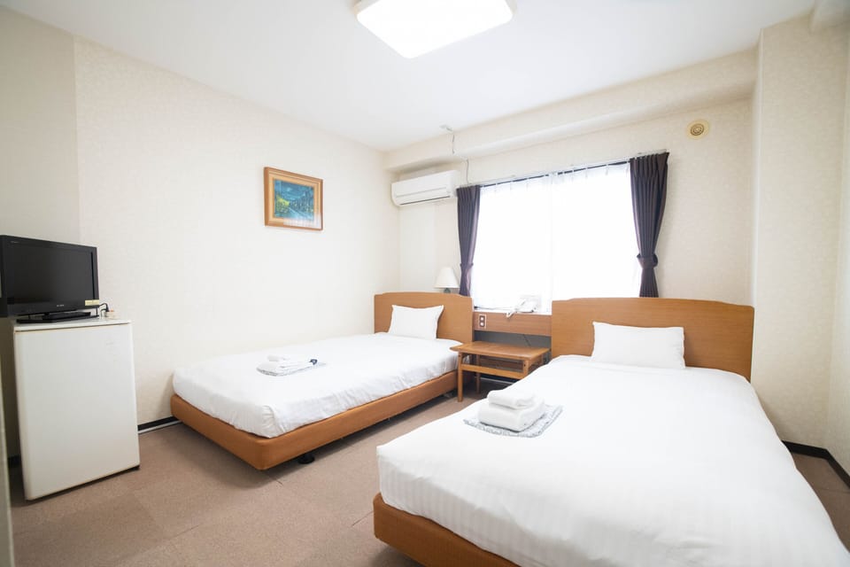 Basic Twin Room | Down comforters, desk, blackout drapes, bed sheets