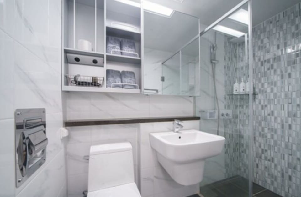 Shower, hair dryer, slippers, towels