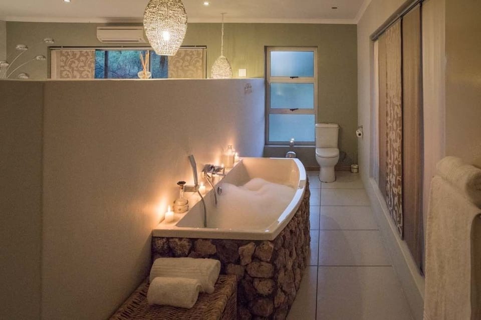 Deep soaking tub, rainfall showerhead, designer toiletries