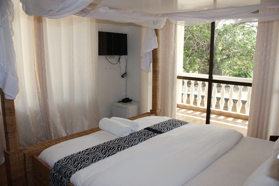 Family Suite, Multiple Beds, Balcony, Partial Ocean View | In-room safe, free WiFi, bed sheets