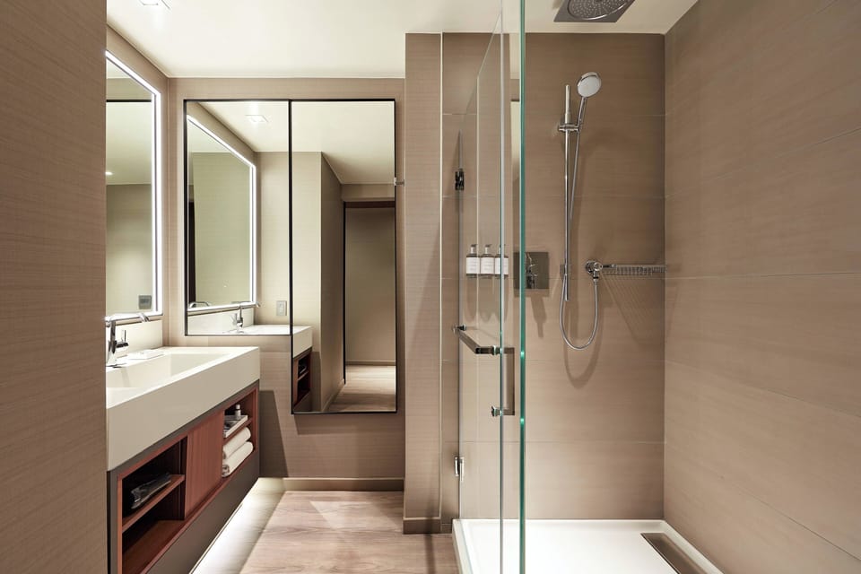 Combined shower/tub, designer toiletries, hair dryer, bathrobes