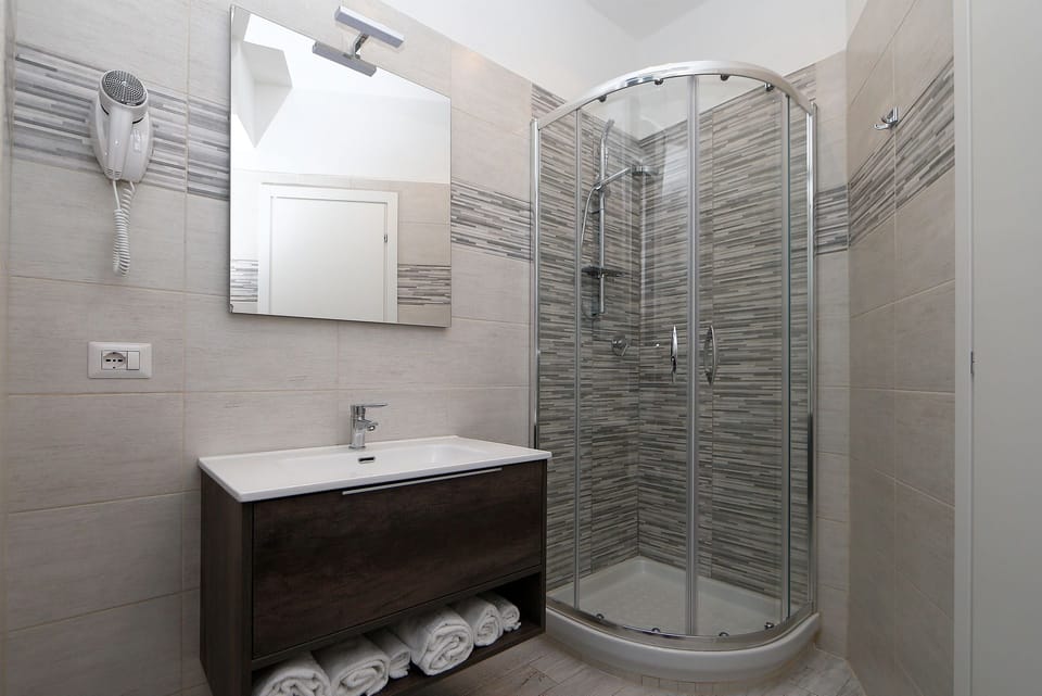 Shower, free toiletries, hair dryer, slippers