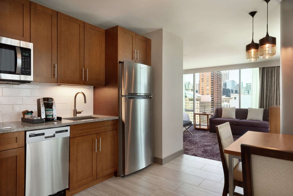 Studio, 1 King Bed, Corner | Private kitchen | Coffee/tea maker, full-size fridge, microwave, stovetop