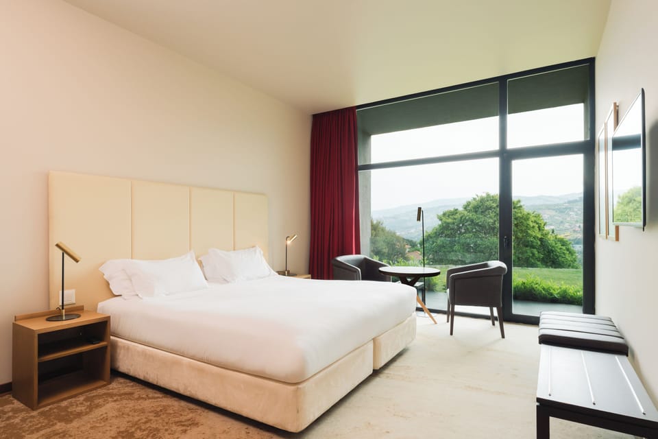Double Room, Garden View | Minibar, in-room safe, desk, blackout drapes