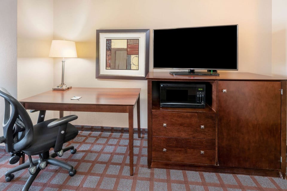 Premium bedding, desk, laptop workspace, blackout drapes