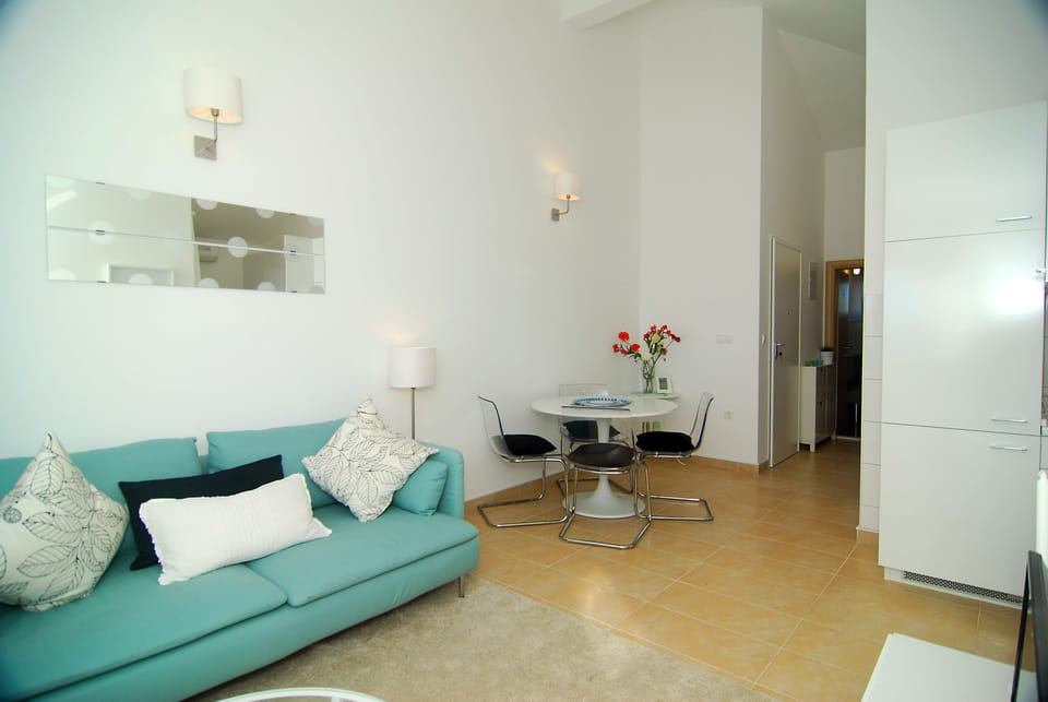 Apartment, Sea View | Living area | Flat-screen TV