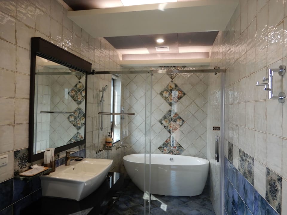 Shower, designer toiletries, hair dryer, slippers