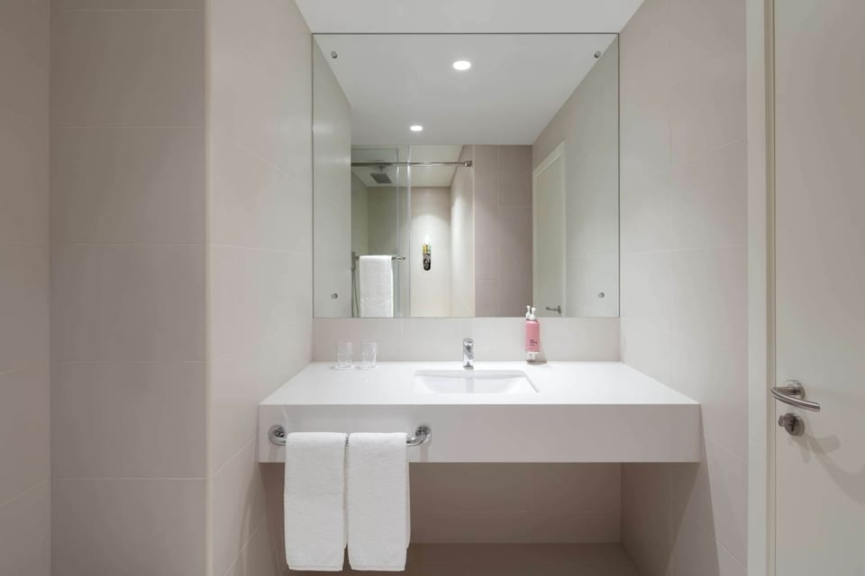 Shower, rainfall showerhead, hair dryer, towels