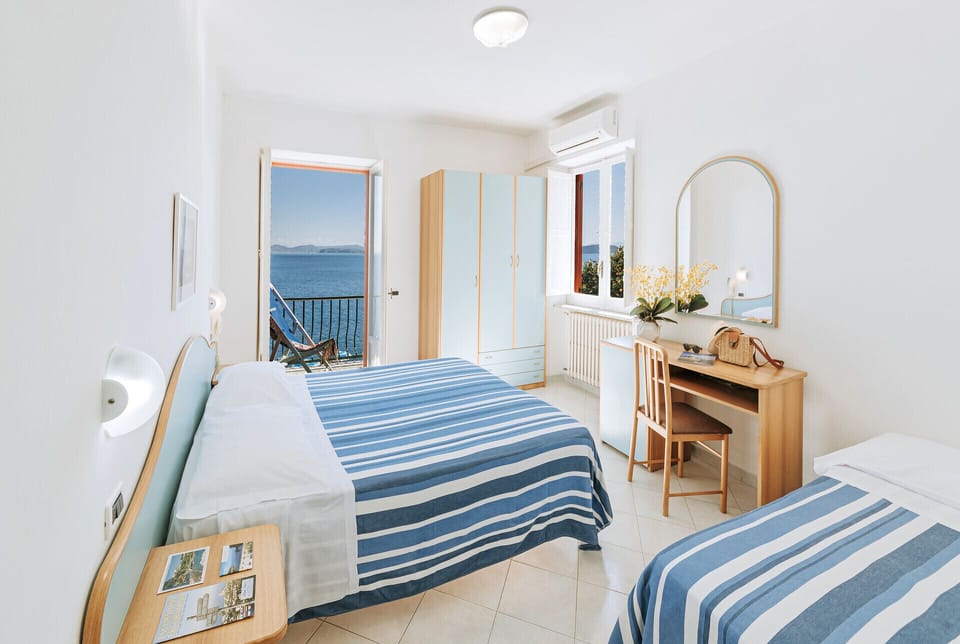 Triple Room, Sea View | Minibar, desk, free WiFi, bed sheets