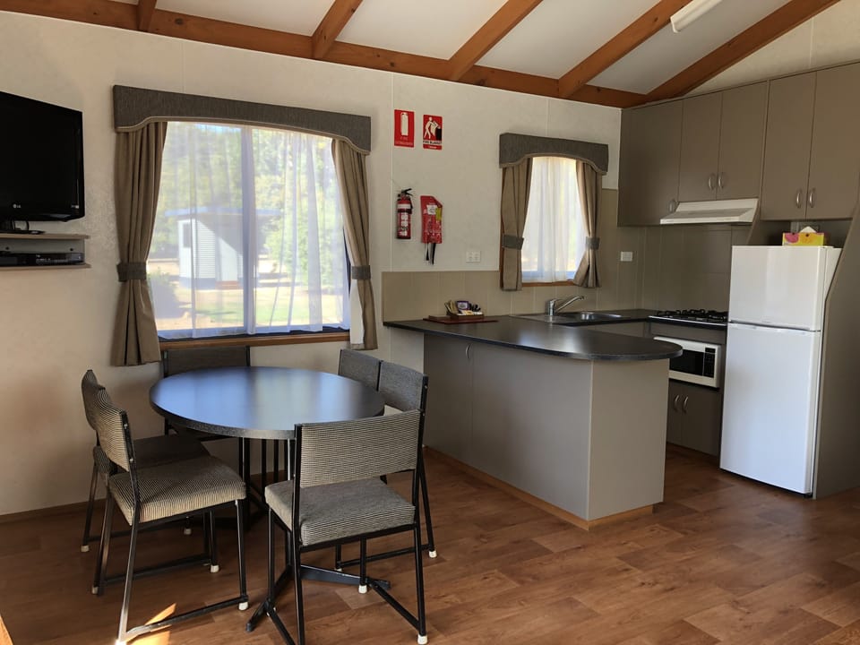 Riverfront Cabin | Private kitchen | Full-size fridge, microwave, stovetop, electric kettle