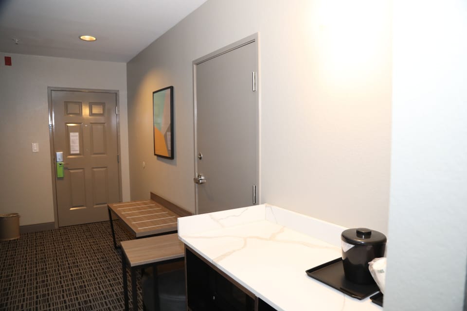 Premium bedding, desk, laptop workspace, blackout drapes