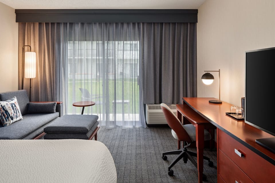 Premium bedding, desk, laptop workspace, blackout drapes