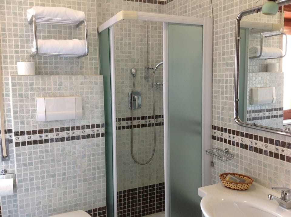 Quadruple Room | Bathroom | Rainfall showerhead, free toiletries, hair dryer, slippers