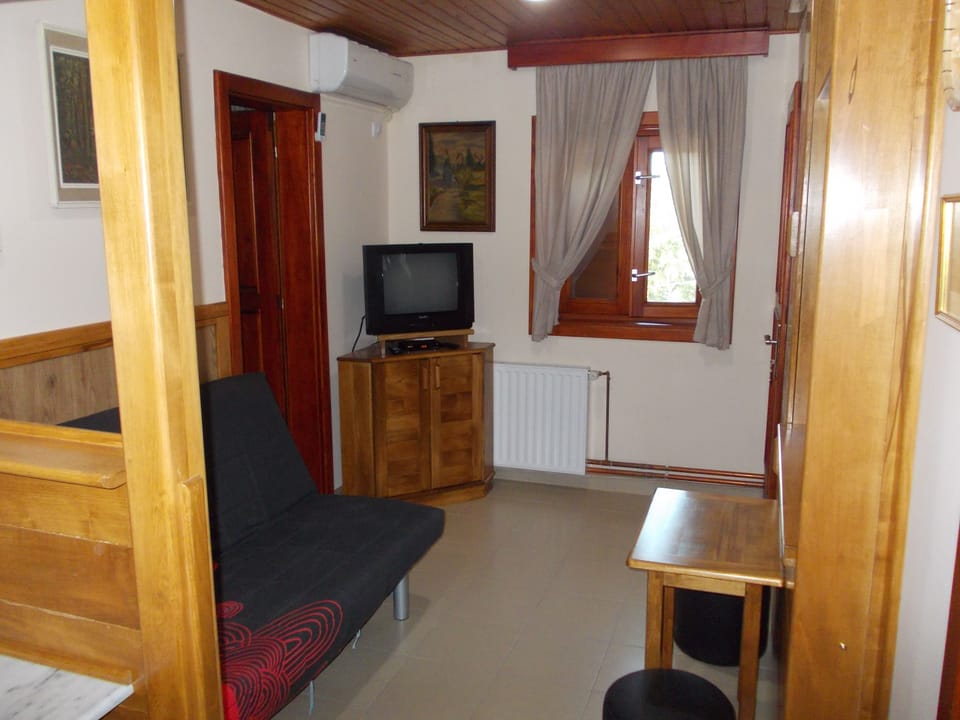 Apartment, 1 Bedroom | Living room | Flat-screen TV