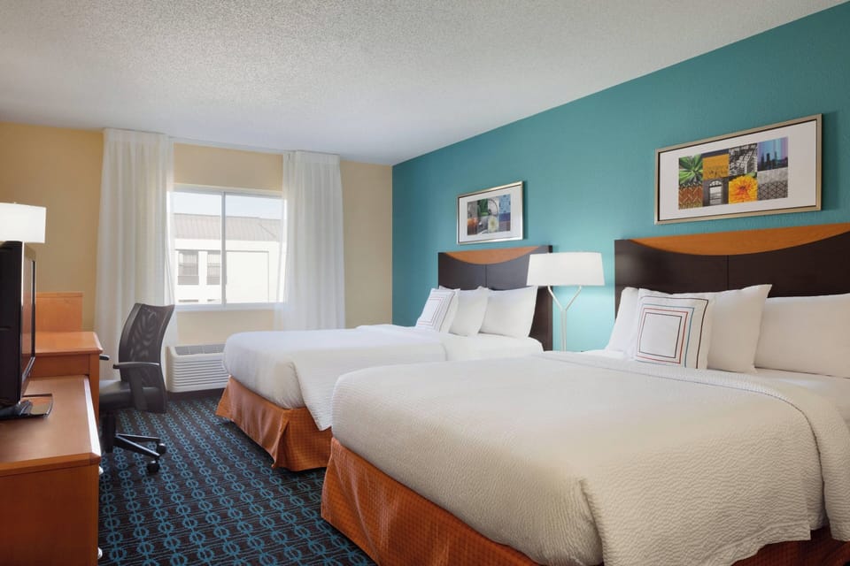 Room, 2 Queen Beds | Desk, blackout drapes, iron/ironing board, free cribs/infant beds