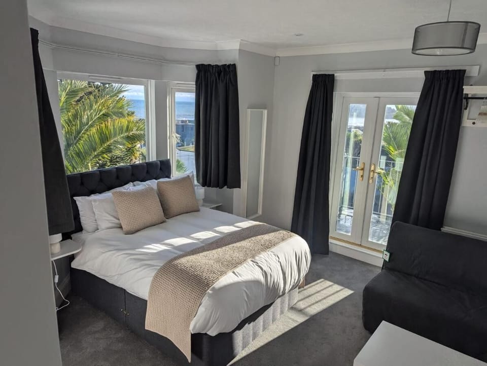Family Suite, Balcony, Sea View | Desk, laptop workspace, blackout drapes, iron/ironing board