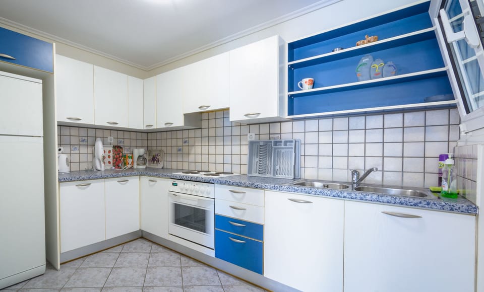 Family Apartment, Beach View | Private kitchen | Full-size fridge, oven, stovetop, electric kettle